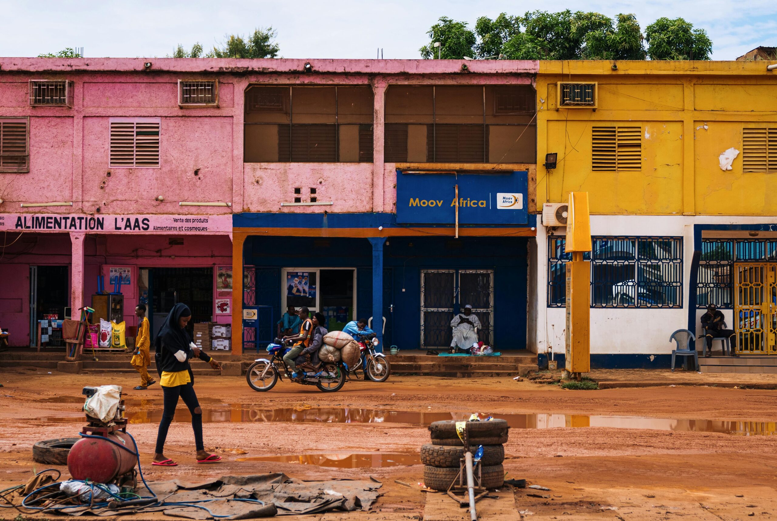 Vibrant city street in Africa with colorful buildings and local activity.